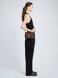 Proenza Schouler image of model wearing PS1 Mini Crossbody Bag in chestnut
