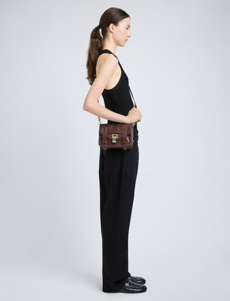 Proenza Schouler image of model wearing PS1 Mini Crossbody Bag in chestnut