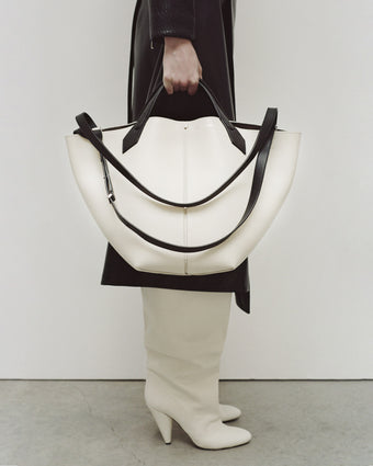 Image of model holding Large Chelsea Tote in ivory/black