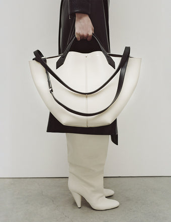 Image of model holding Large Chelsea Tote in ivory/black