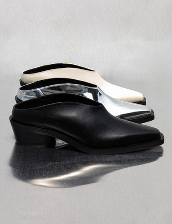 Row of Bronco Mules in black, silver, and cream on silver backdrop
