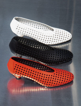 Line of Perforated Cone Pumps - 40mm in red, black, and cream on silver backdrop