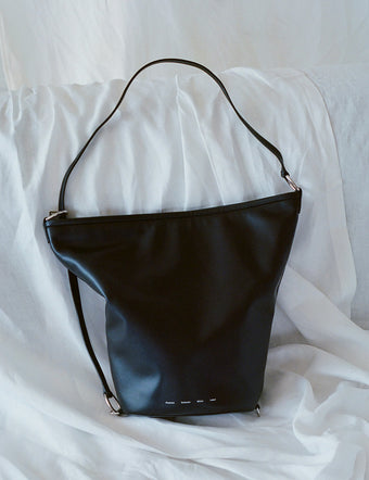 Spring Bag in black on white fabric backdrop