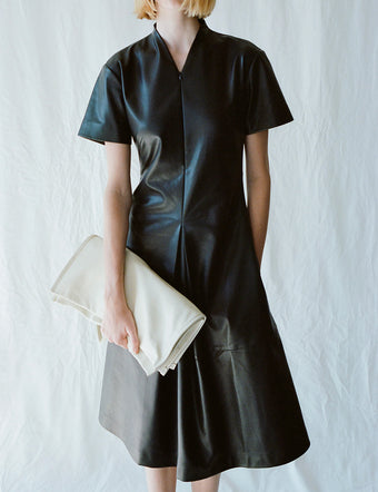 Cropped image of model in Esther Dress in black, holding Nappa Twin Tote in ivory