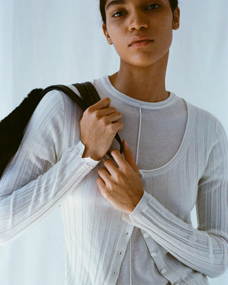 Cropped image of model wearing Hattie Cardigan and Ares Shirt in Lightweight Cashmere in ivory