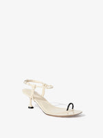 Front 3/4 image of the Tee Toe Ring Sandals in cream/black