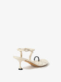 Back 3/4 image of the Tee Toe Ring Sandals in cream/black
