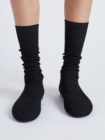 Image of model wearing Tee Knit Sock Boots in black