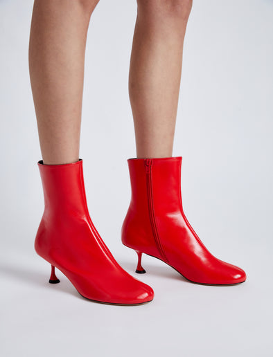 Proenza Schouler cropped image of model wearing Tee Ankle Boots in RED