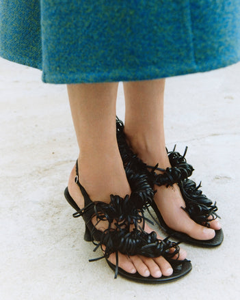 A detail crop of the tee loop fringe sandals