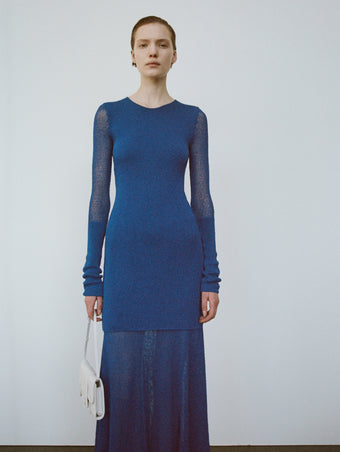 Cropped image of model wearing Anita Dress in Knit Sheer Mesh in bright blue, carrying Flip Shoulder Bag in white.