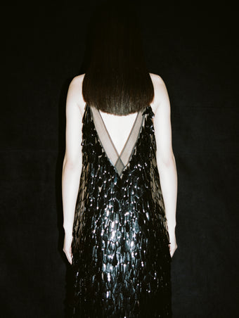 Cropped image of model's back, wearing Irene Dress in Resin Embroidered Organza in black.