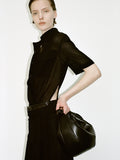 Cropped image of a model wearing Emory Dress in Mesh in black, carrying a Slide Bag in black.