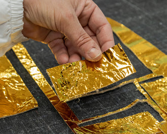 metallic gold foil being put together for gold drawstring bag