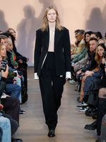 Runway image of model wearing Wool Twill Trousers in BLACK