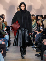Runway image of model wearing Technical Boucle Knit Hoodie in CHARCOAL