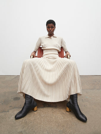 PF23 Collection Look 10: Ecru Metallic Knit Polo, Ecru Metallic Knit Dress, and Black Sculpt Ankle Boots with Gold Heel