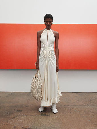 PF23 Collection Look 11: Ivory Crepe Jersey Dress, Ecru Macrame Drawstring Tote, and Optic White Sculpt Ankle Boots