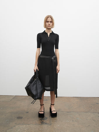 PF23 Collection Look 12: Black Crepe Chiffon Skirt, Black Silk Viscose Knit Bodysuit, Black Drawstring Shoulder Bag, and Black Velvet Square Platform Sandals