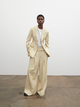 PF23 Collection Look 14: Parchment Viscose Suiting Jacket, White Terry Jersey T-Shirt, Parchment Viscose Suiting Pant, and Black Stomp Mules