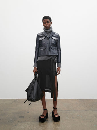 PF23 Collection Look 17: Navy Glossy Leather Jacket, Grey Melange Doubleface Cashmere Turtleneck, Black Crepe Chiffon Skirt, and Black Velvet Square Platform Sandals