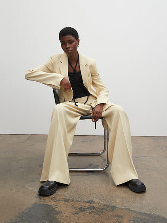 PF23 Collection Look 07: Parchment Viscose Suiting Jacket, Black Compact Jersey Bodysuit, Parchment Viscose Suiting Pant, and Black Stomp Mules
