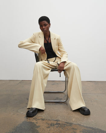 PF23 Collection Look 07: Parchment Viscose Suiting Jacket, Black Compact Jersey Bodysuit, Parchment Viscose Suiting Pant, and Black Stomp Mules