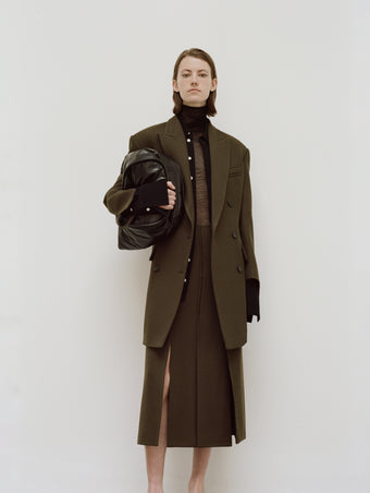 PS24 Look 13 - Black Sheer Viscose Knit Top, Black Maya Shirt in Textured Marocaine, Dark Loden Diane Skirt, Dark Loden Henri Coat, Black Large Puffy Nappa Ruched Tote, and Black Bronco Mules