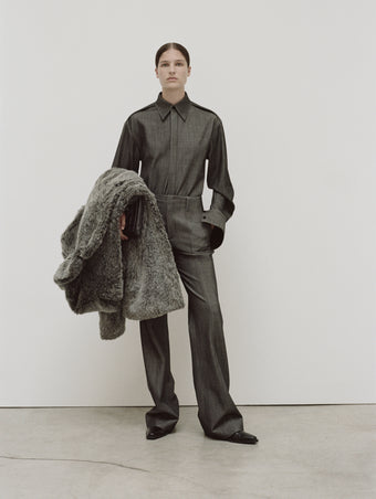 PS24 Look 03 - Grey Melange Maya Shirt in Melange Wool, Grey Melange Barbara Pant in Melange Wool, Dark Grey Melange Isa Coat in Faux Shearling, Black Triple Zip Pouch, and Black Bronco Ankle Boots.