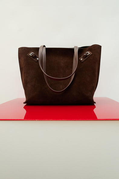 Image of Days Tote in Soft Suede in Chocolate on red platform
