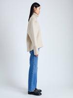 Side image of model wearing Doubleface Eco Cashmere Oversized Turtleneck Sweater in OATMEAL