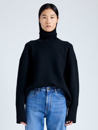 Front cropped image of model wearing Doubleface Eco Cashmere Oversized Turtleneck Sweater in BLACK