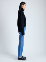 Side image of model wearing Doubleface Eco Cashmere Oversized Turtleneck Sweater in BLACK