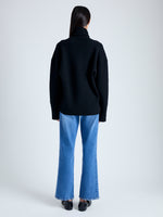Back image of model wearing Doubleface Eco Cashmere Oversized Turtleneck Sweater in BLACK