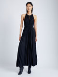 Front image of model wearing Frida Halter Dress in Sheer Pleated Chiffon in black