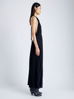 Side image of model wearing Frida Halter Dress in Sheer Pleated Chiffon in black