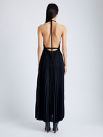 Back image of model wearing Frida Halter Dress in Sheer Pleated Chiffon in black