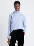 Cropped front view of model wearing Camilla Sweater In Lofty Eco Cashmere in pale blue