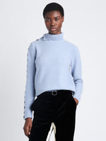 Cropped front view of model wearing Camilla Sweater In Lofty Eco Cashmere in pale blue