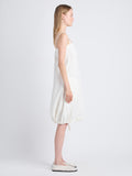 Side full length image of model wearing Emilia Dress In Lightweight Crinkle Poplin in OFF WHITE