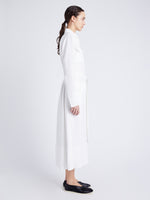 Side image of model wearing Vanessa Dress in Matte Viscose Crepe in white