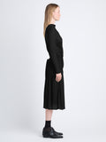 Side image of model wearing Riley Dress In Pleated Jersey in black
