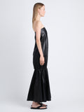 Side image of model in Margot Dress In Glossy Leather in black