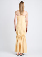 Back image of model in Margot Dress In Glossy Leather in resin