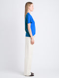 Side image of model wearing Talia V shirt in blue