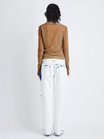 Back image of model wearing Dara Layered Top in Technical Nylon Jersey in terracotta
