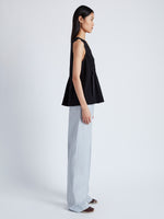 Side image of model wearing Casey Top in Matte Viscose Crepe in black