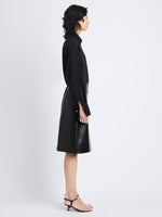 Side image of model wearing Adele Skirt In Leather in black