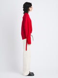 Side full length image of model wearing Amy Sweater In Viscose Boucle in RED