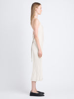 Side image of model wearing Vida Dress In Viscose Rib in eggshell